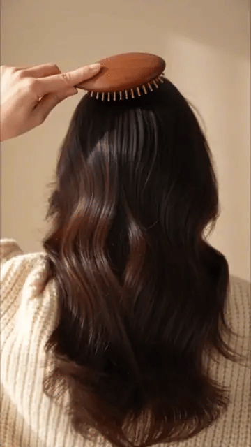Brushing long dark hair with the HairGuard wooden brush